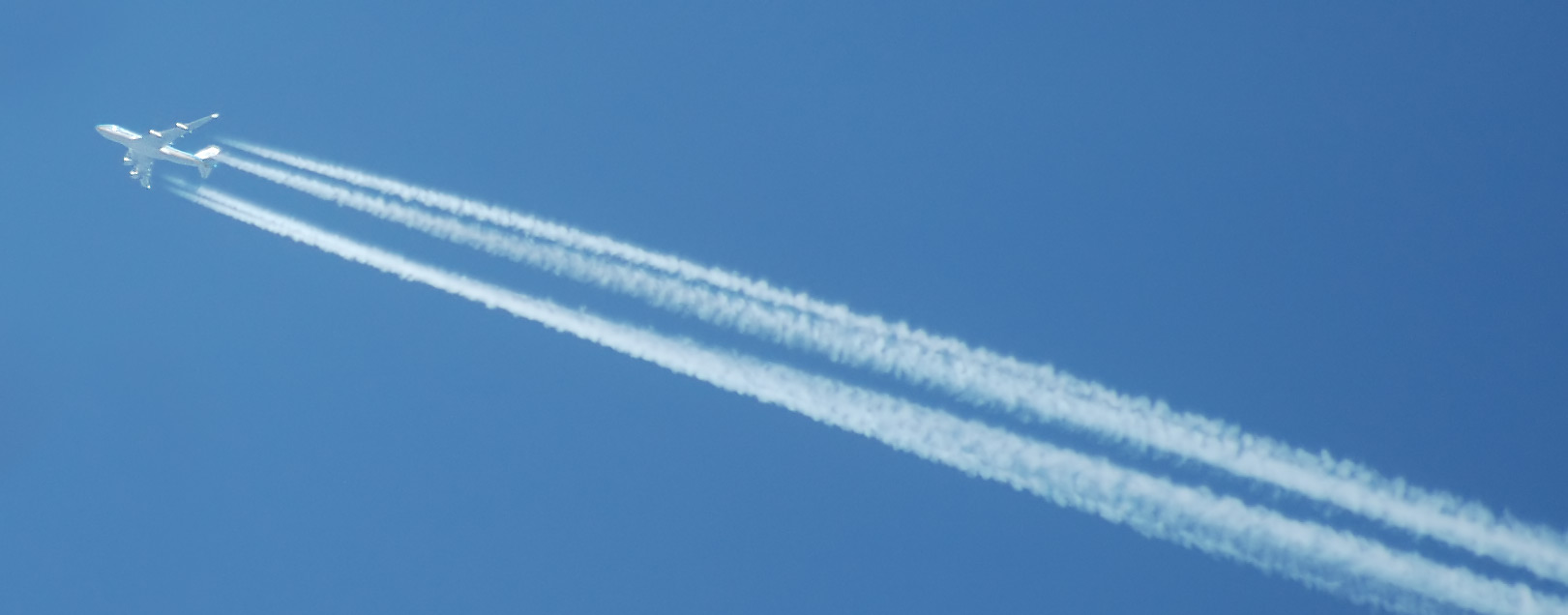 An aircraft crossing a clear blue sky